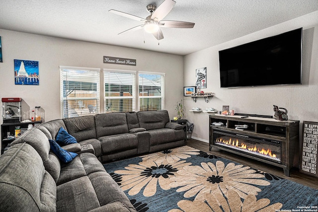 7129 Pisces, Converse, TX 78109 - living room with wood finished floors, ceiling fan, a textured ceiling, baseboards, and a glass covered fireplace
