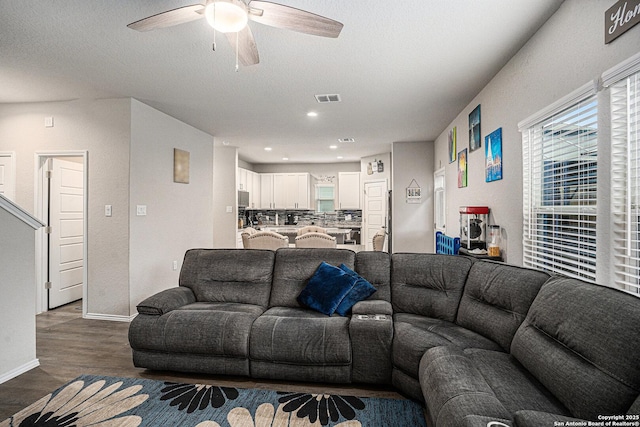 7129 Pisces, Converse, TX 78109 - living area featuring a ceiling fan, dark wood-style floors, and baseboards