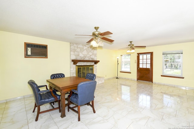 5803 Hollyhock, San Antonio, TX 78240 - dining space with light marble finish flooring, a wall unit AC, ceiling fan, and baseboards