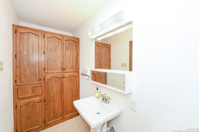 5803 Hollyhock, San Antonio, TX 78240 - bathroom with a sink and a textured ceiling