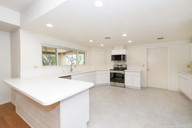 5803 Hollyhock, San Antonio, TX 78240 - kitchen featuring stainless steel appliances, a peninsula, light countertops, a sink, and recessed lighting