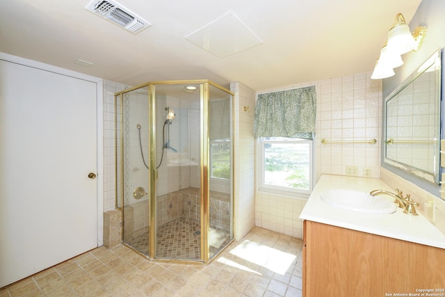 5803 Hollyhock, San Antonio, TX 78240 - full bathroom with vanity, a stall shower, tile walls, and tile patterned floors