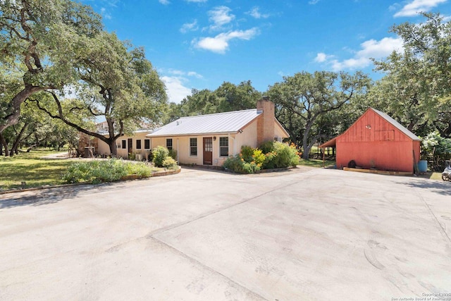 5803 Hollyhock, San Antonio, TX 78240 - view of front of house featuring a chimney, metal roof, and a standing seam roof