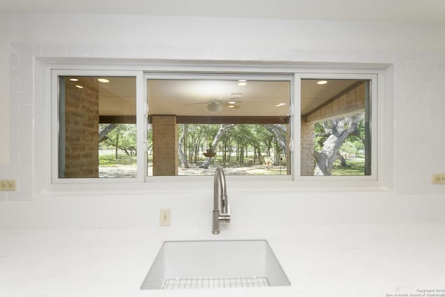 5803 Hollyhock, San Antonio, TX 78240 - kitchen view of a sink, a ceiling fan, and light countertops