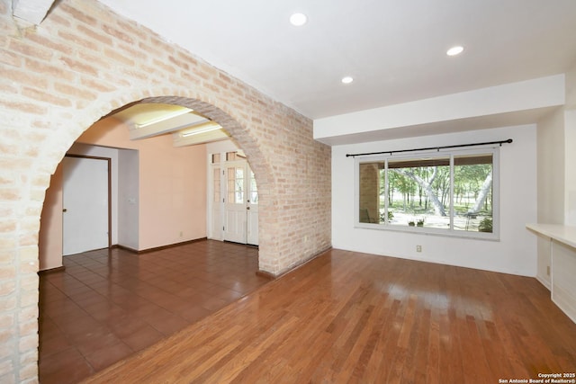 5803 Hollyhock, San Antonio, TX 78240 - unfurnished living room with arched walkways, recessed lighting, and wood finished floors