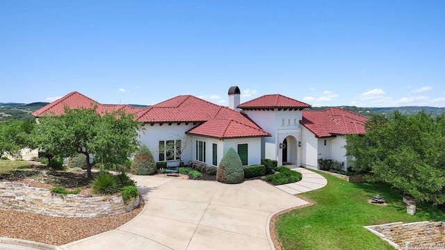 23510 Avila, San Antonio, TX 78255 - mediterranean / spanish-style house featuring a tiled roof, stucco siding, a front yard, and a chimney