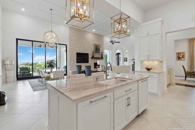 23510 Avila, San Antonio, TX 78255 - kitchen featuring a high ceiling, a sink, a chandelier, coffered ceiling, and light stone countertops