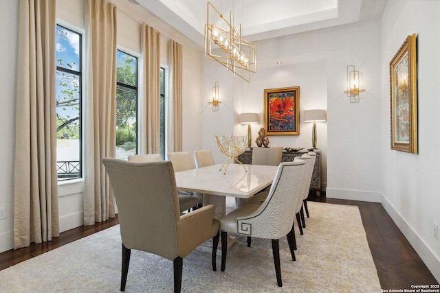 23510 Avila, San Antonio, TX 78255 - dining area featuring dark wood-style floors, baseboards, a chandelier, and a raised ceiling