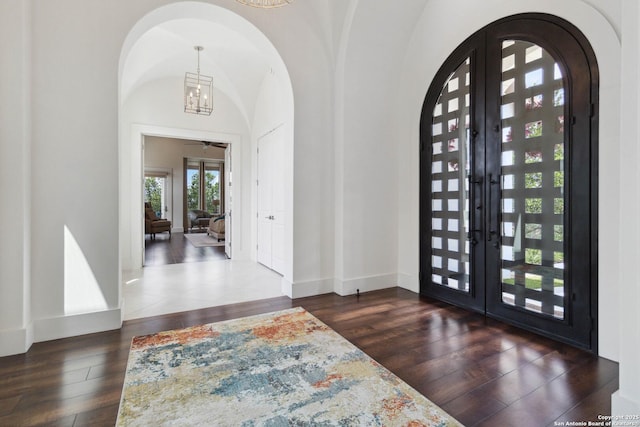 23510 Avila, San Antonio, TX 78255 - entrance foyer featuring french doors, arched walkways, hardwood / wood-style floors, and a chandelier