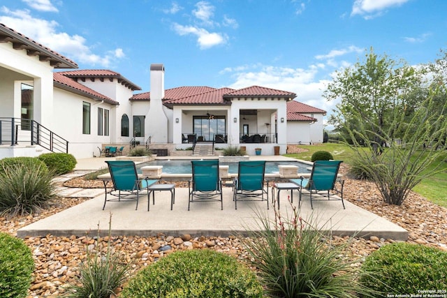 23510 Avila, San Antonio, TX 78255 - back of house featuring a patio, a chimney, a tiled roof, stucco siding, and an outdoor pool