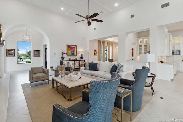23510 Avila, San Antonio, TX 78255 - living area with light tile patterned flooring, arched walkways, a high ceiling, coffered ceiling, and recessed lighting