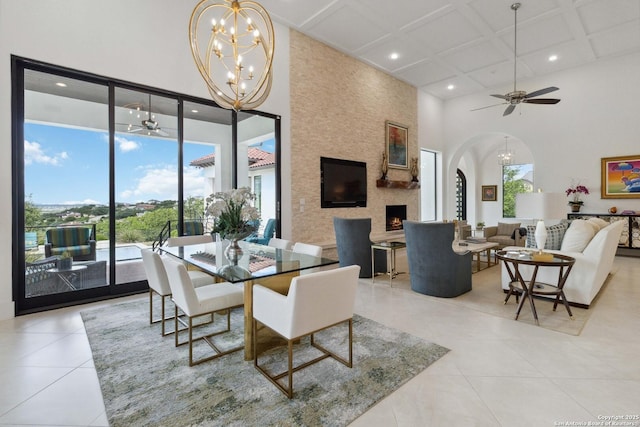 23510 Avila, San Antonio, TX 78255 - dining room featuring a high ceiling, a chandelier, coffered ceiling, a ceiling fan, and light tile patterned floors