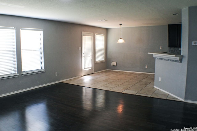 8815 Adhinger, San Antonio, TX 78245 - unfurnished living room with light wood-style floors and baseboards