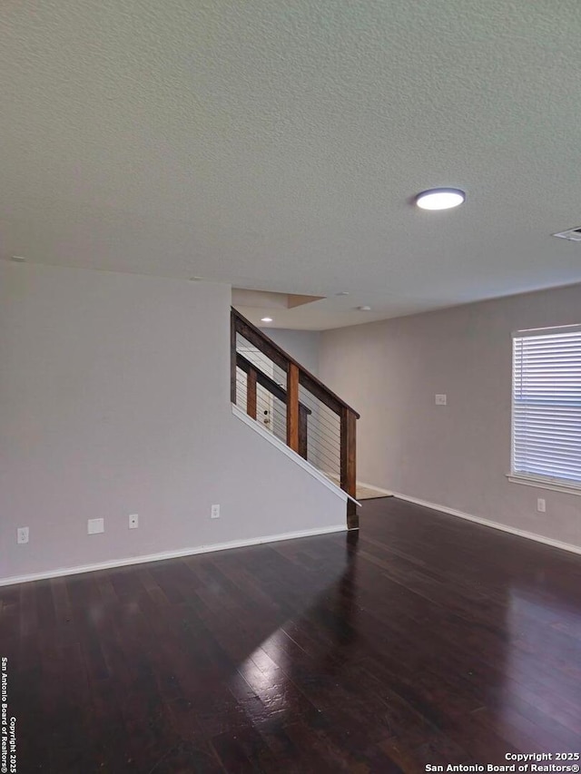 8815 Adhinger, San Antonio, TX 78245 - unfurnished living room with stairway, wood finished floors, baseboards, a textured ceiling, and recessed lighting