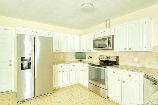 15018 Miss Ellie Dr, San Antonio, TX 78247 - kitchen with appliances with stainless steel finishes, decorative backsplash, light stone countertops, and white cabinetry