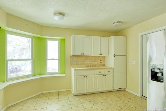 15018 Miss Ellie Dr, San Antonio, TX 78247 - kitchen featuring healthy amount of natural light, tasteful backsplash, light countertops, a textured ceiling, and white cabinets