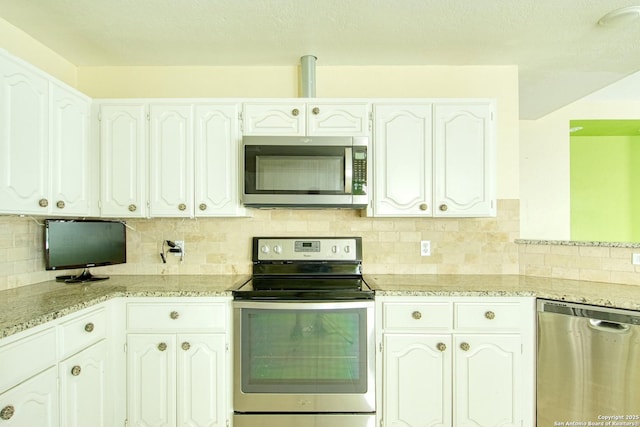 15018 Miss Ellie Dr, San Antonio, TX 78247 - kitchen featuring appliances with stainless steel finishes, tasteful backsplash, light stone counters, and white cabinetry