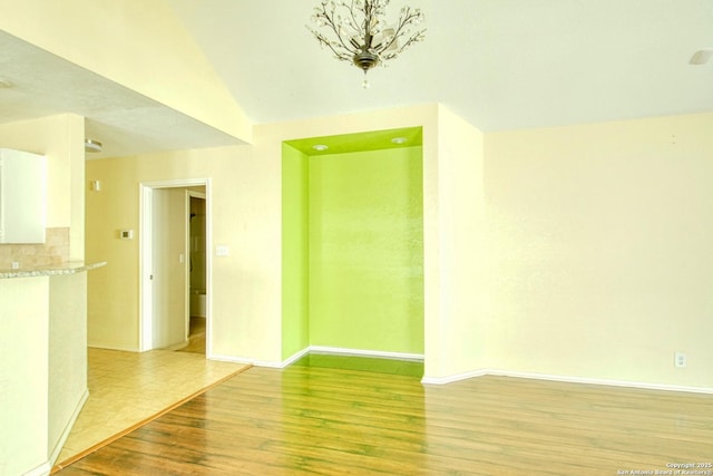 15018 Miss Ellie Dr, San Antonio, TX 78247 - spare room with baseboards, light wood finished floors, and vaulted ceiling