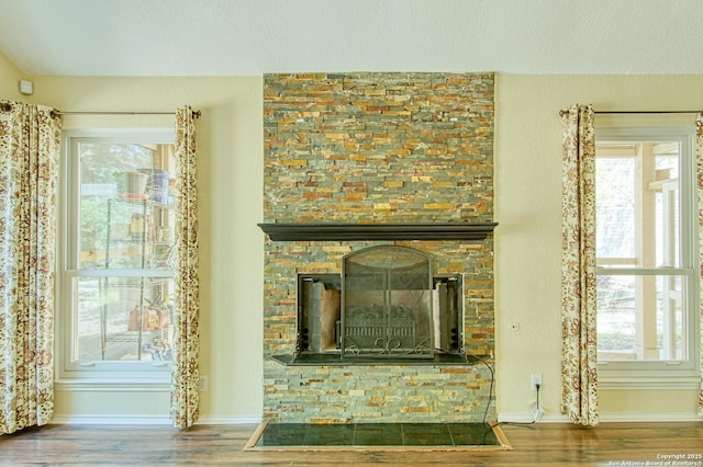 15018 Miss Ellie Dr, San Antonio, TX 78247 - detailed view of wood finished floors, baseboards, and a stone fireplace