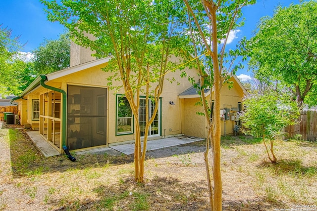 15018 Miss Ellie Dr, San Antonio, TX 78247 - back of house featuring cooling unit, a sunroom, stucco siding, and a patio