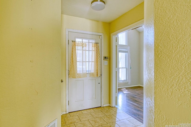 15018 Miss Ellie Dr, San Antonio, TX 78247 - entryway featuring a textured wall, light tile patterned floors, and baseboards