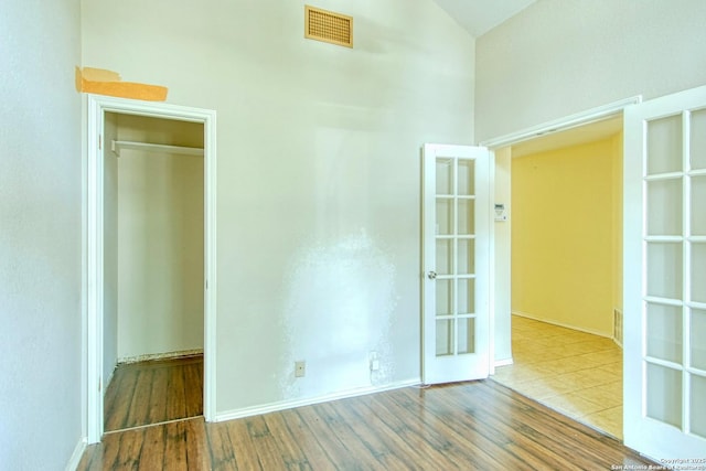 15018 Miss Ellie Dr, San Antonio, TX 78247 - unfurnished bedroom with wood finished floors, a closet, high vaulted ceiling, and baseboards