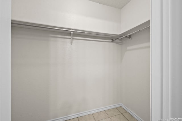9387 Village Lance, San Antonio, TX 78250 - walk in closet with light tile patterned floors