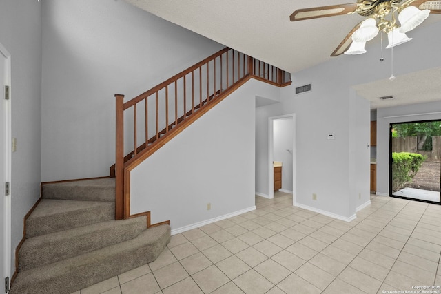 9387 Village Lance, San Antonio, TX 78250 - foyer featuring ceiling fan, stairway, baseboards, and light tile patterned floors