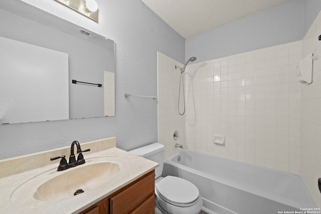 9387 Village Lance, San Antonio, TX 78250 - bathroom with toilet, vanity, shower / tub combination, a textured wall, and a textured ceiling