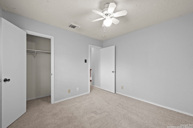9387 Village Lance, San Antonio, TX 78250 - unfurnished bedroom with carpet floors, a closet, baseboards, a ceiling fan, and a textured ceiling