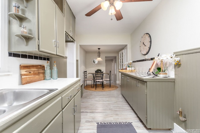305 Kendalia, San Antonio, TX 78214 - kitchen featuring a ceiling fan, tasteful backsplash, light countertops, light wood-type flooring, and a sink