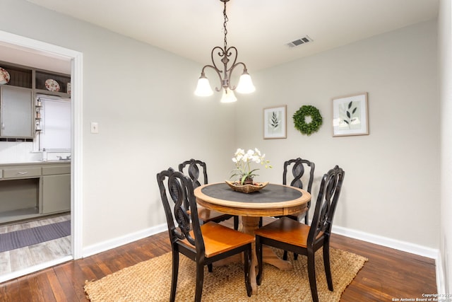 305 Kendalia, San Antonio, TX 78214 - dining room with a chandelier, baseboards, and dark wood-style floors