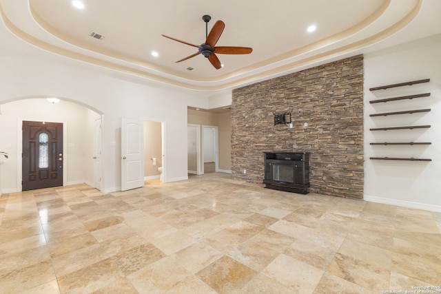 22919 Hightop, Elmendorf, TX 78112 - unfurnished living room featuring a tray ceiling, ceiling fan, a fireplace, recessed lighting, and baseboards