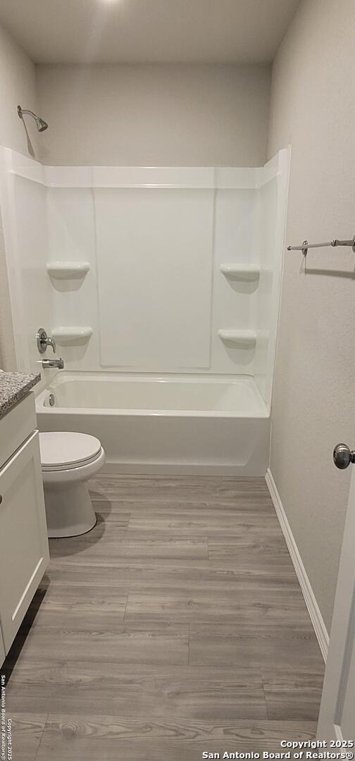 10814 Prusiner, Converse, TX 78109 - full bath featuring toilet, vanity, bathtub / shower combination, and wood finished floors