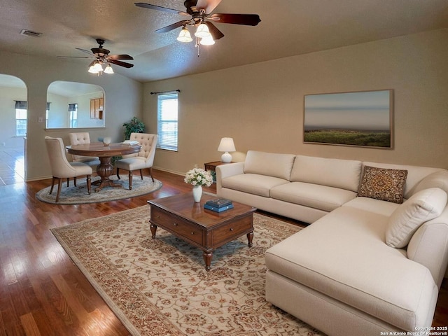 219 Starling, New Braunfels, TX 78130 - living area featuring arched walkways, wood finished floors, baseboards, ceiling fan, and vaulted ceiling