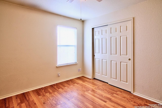219 Starling, New Braunfels, TX 78130 - unfurnished bedroom featuring light wood-type flooring, a closet, baseboards, and ceiling fan