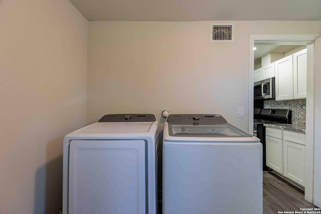 1309 Quintana Rd, San Antonio, TX 78211 - laundry area with washing machine and dryer and dark wood-style flooring