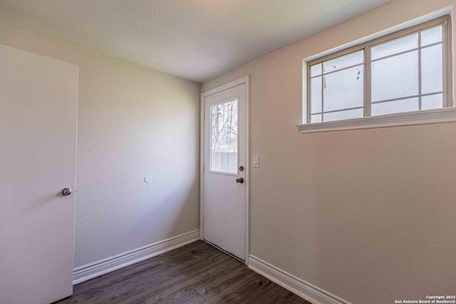 1309 Quintana Rd, San Antonio, TX 78211 - doorway to outside with baseboards and dark wood-style flooring