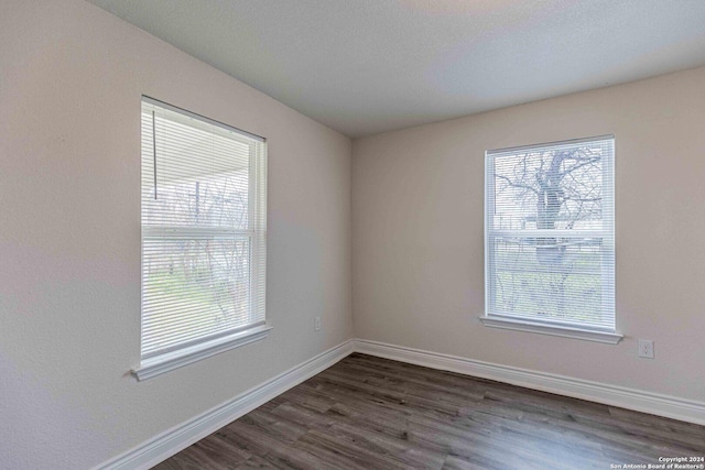 1309 Quintana Rd, San Antonio, TX 78211 - empty room featuring dark wood-type flooring and baseboards
