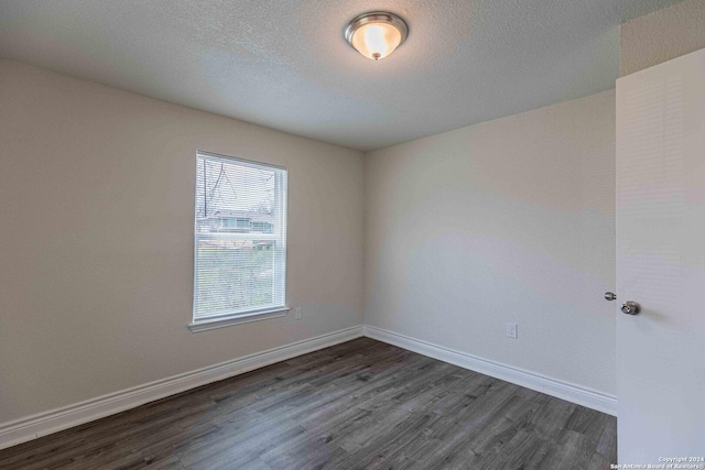 1309 Quintana Rd, San Antonio, TX 78211 - spare room with dark wood-type flooring and baseboards