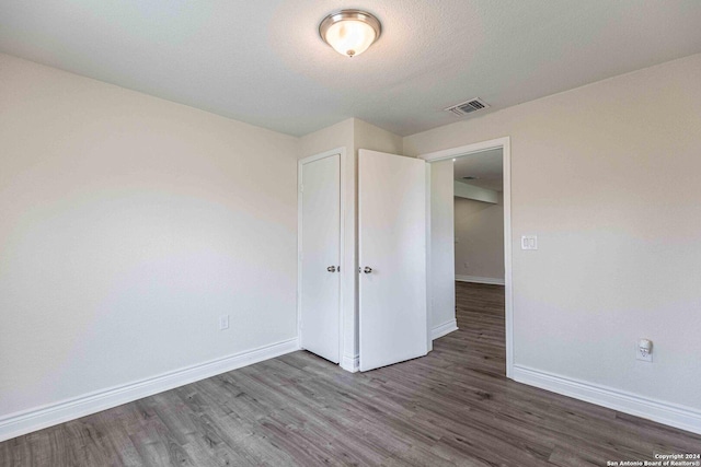 1309 Quintana Rd, San Antonio, TX 78211 - unfurnished bedroom with baseboards and wood finished floors
