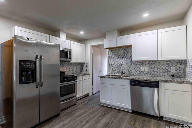 1309 Quintana Rd, San Antonio, TX 78211 - kitchen featuring appliances with stainless steel finishes, a sink, white cabinets, and recessed lighting