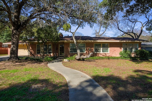 215 Five Oaks, San Antonio, TX 78209 - ranch-style house with brick siding, a chimney, and a front lawn