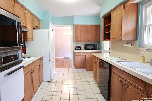 215 Five Oaks, San Antonio, TX 78209 - kitchen with black appliances, a sink, light countertops, and under cabinet range hood