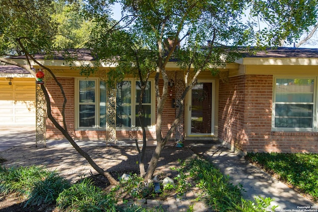 215 Five Oaks, San Antonio, TX 78209 - view of front facade featuring brick siding and an attached garage