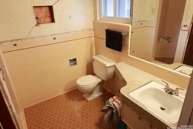 215 Five Oaks, San Antonio, TX 78209 - bathroom featuring toilet, tile walls, vanity, a wainscoted wall, and a shower