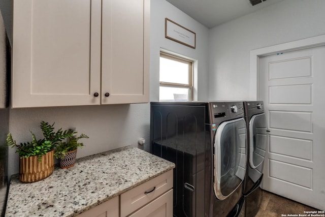 24435 Canyon Row, San Antonio, TX 78260 - washroom with cabinet space, washer and clothes dryer, and dark wood-type flooring