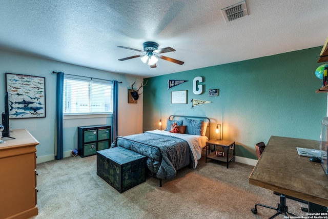 24435 Canyon Row, San Antonio, TX 78260 - bedroom featuring light carpet, an office area, a textured ceiling, ceiling fan, and baseboards