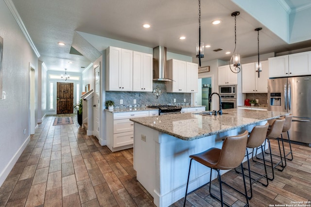 24435 Canyon Row, San Antonio, TX 78260 - kitchen featuring appliances with stainless steel finishes, wall chimney exhaust hood, crown molding, backsplash, and a sink