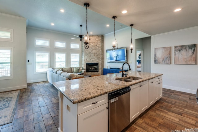 24435 Canyon Row, San Antonio, TX 78260 - kitchen with stainless steel dishwasher, a sink, crown molding, a stone fireplace, and baseboards